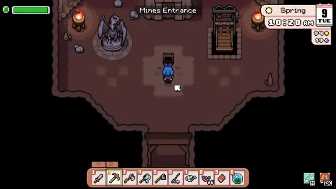 Mines Entrance in Fields of Mistria with the dragon statue and the elevator cage